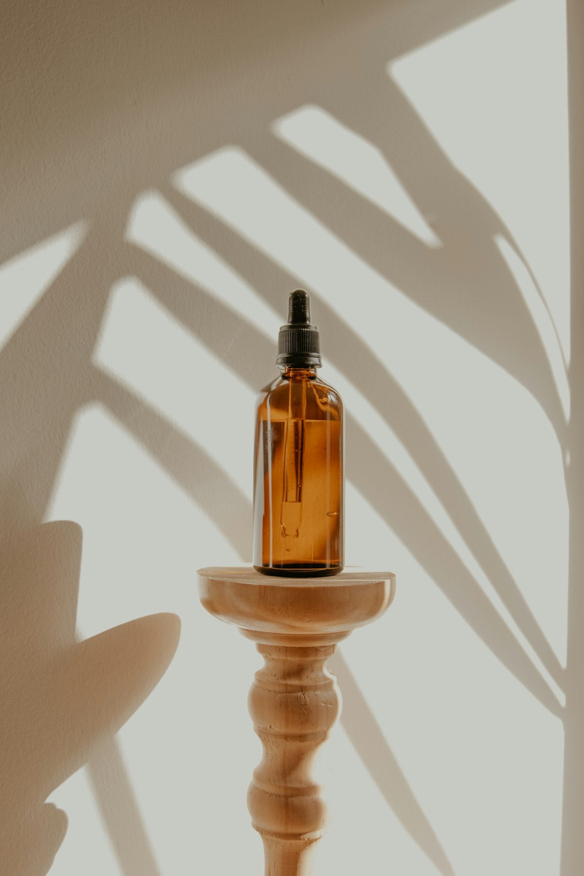 Natural beauty oils and botanical ingredients on warm background